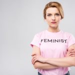 confident-woman-in-pink-feminist-t-shirt-with-cros-2023-11-27-04-53-51-utc