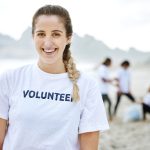 smile-volunteer-portrait-and-woman-at-beach-for-c-2023-11-27-05-03-29-utc